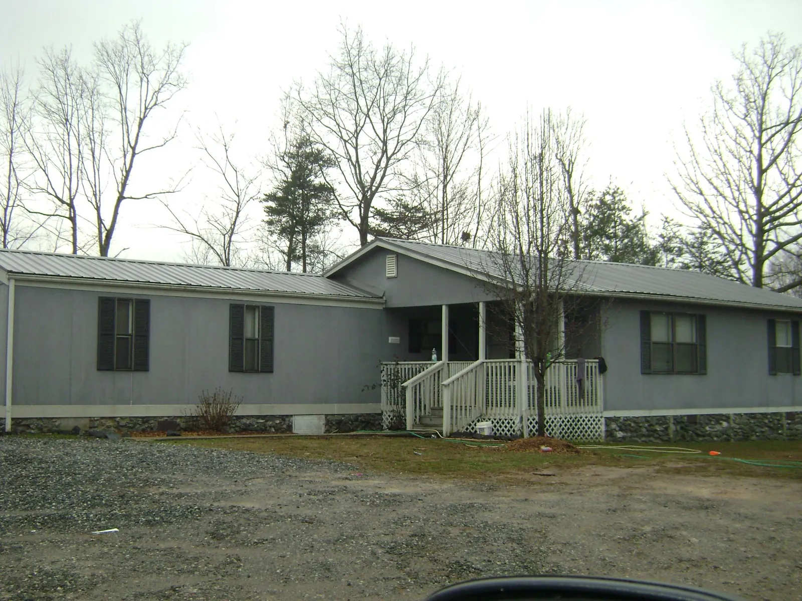 Metal roof over a manufactured home with a covered front porch in Oneco